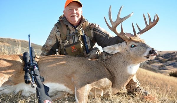 The author smiles behind his great heavy-massed Dakota buck taken with a Savage Model 16 and Fusion 6.5 Creedmoor ammo.