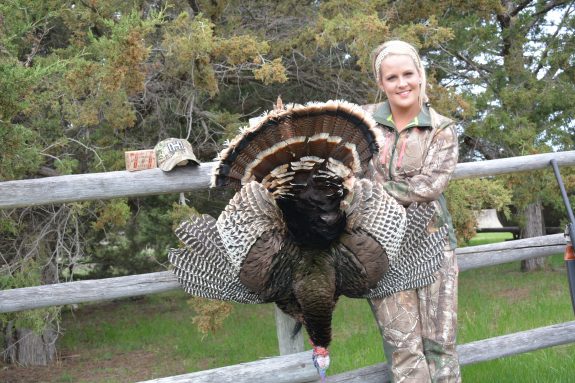 Emily Mierau smiles with her great Merriam's gobbler.